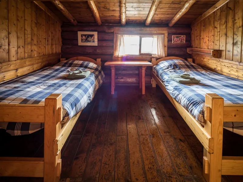Cozy cabin with twin beds and plaid duvets