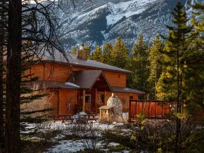 Aurum Lodge main building exterior with mountain backdrop