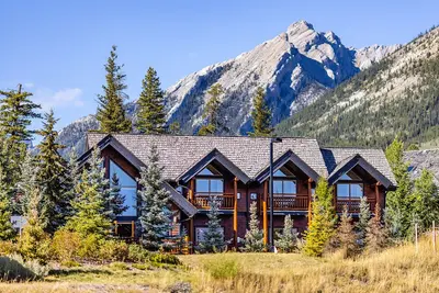 Winter view of A Bear & Bison Inn with Three Sisters Mountains backdrop