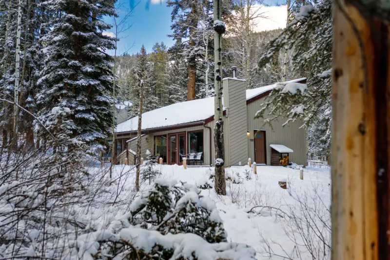 Juniper Hotel cabin exterior in winter with snow
